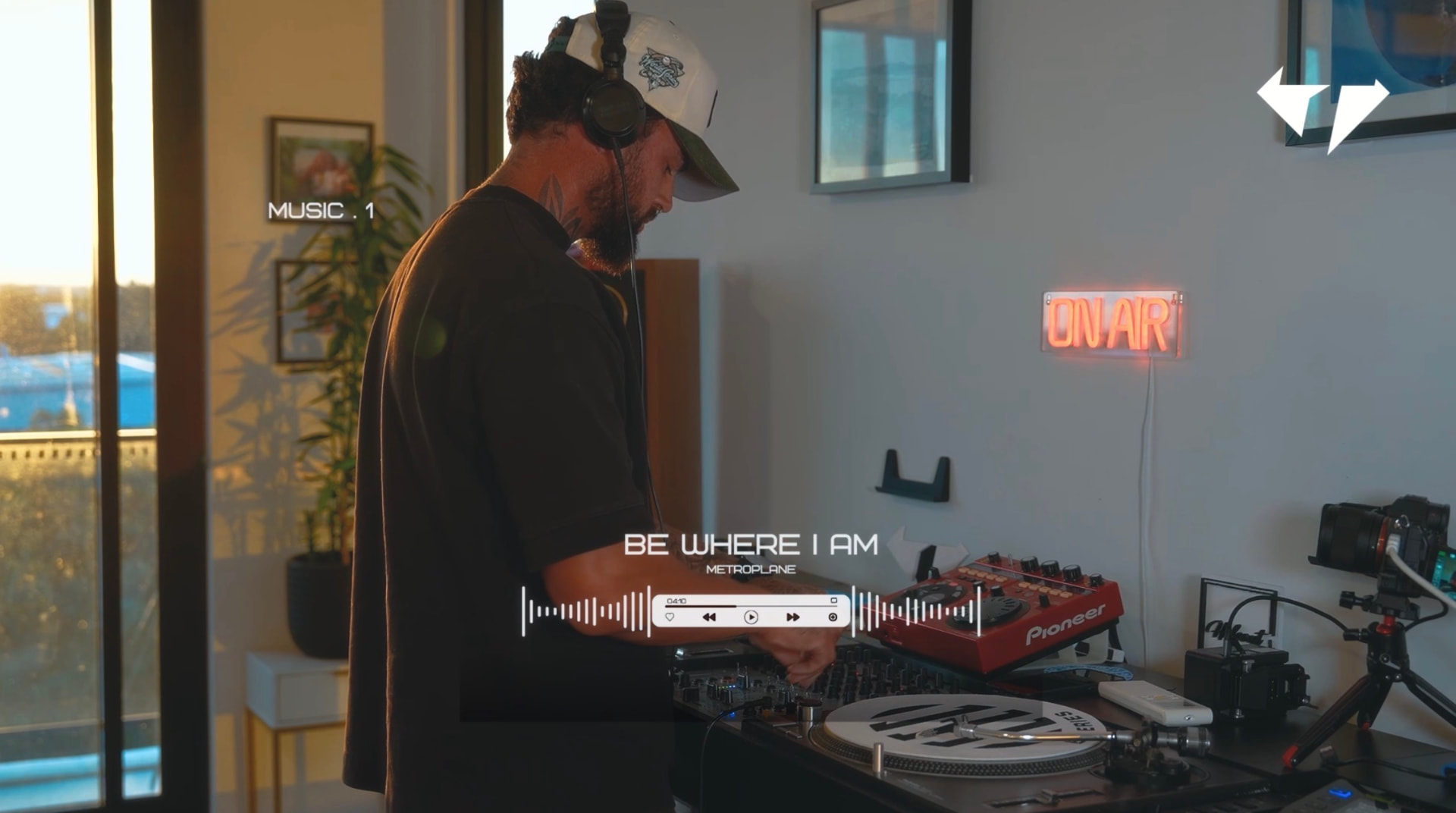 Anderson Darski recording a home studio set with turntables and an ON AIR sign